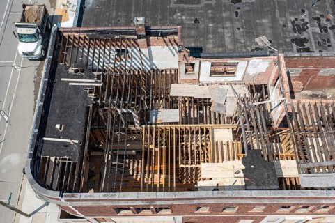 Detroit, Michigan - Workers rehab a long-vacant and crumbling commercial building in the