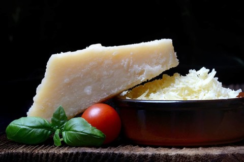 Parmesan cheese, grated cheese in rind and piece of Parmesan, Italy