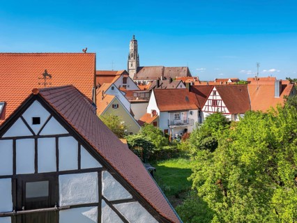 View from the medieval town wall over the houses of the historic old town to the tower of St