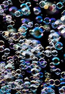 Many, small iridescent and floating soap bubbles against a black background, Recklinghausen, North