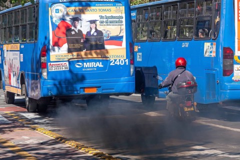 Buses in motion emitting pollution, City of Quito. Pichincha province, Ecuador, South America