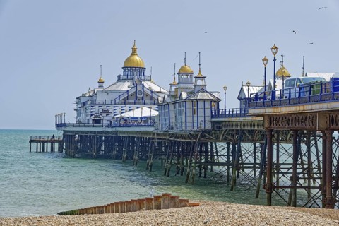 Beach and pier in Eastbourne, seaside resort on the English Channel, in the county of East Sussex,