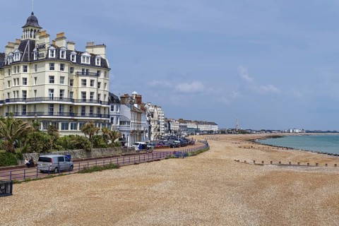 Beach and building on the seafront in Eastbourne, seaside resort on the English Channel, in the