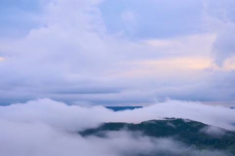 Dense fog over a hilly landscape with colourful morning sky and clouds, summer, Rhine bend Boppard,