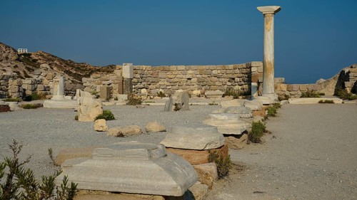 Historical site with remains of columns and detailed stone blocks in the open air, Agios Stefanos