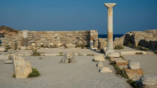 Ancient site with a single stone column and ruins, near the sea, Agios Stefanos Beach, Agios