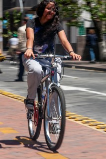 Woman riding a bicycle, Photo with motion blur, City of Quito, Pichincha province, Ecuador, South