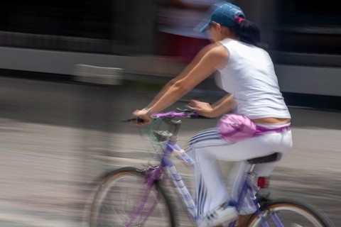 Woman riding a bicycle, Photo with motion blur, City of Quito, Pichincha province, Ecuador, South