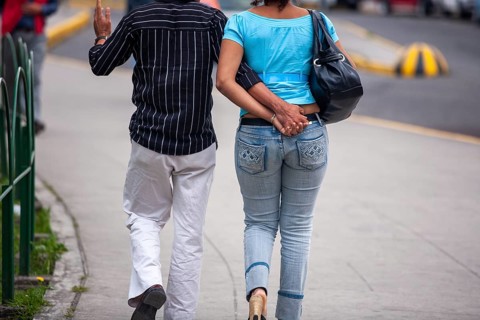 Couple walking in street, Hand in hand, City of Quito, Pichincha province, Ecuador, South America