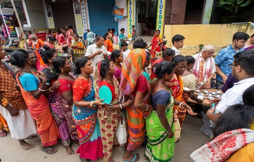 Devotees throng to have food as they arrives to visit Kamakhya Temple during Ambubachi Mela, in