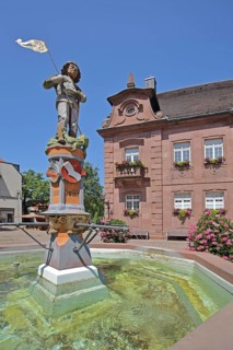 Sculpture of St George with lance, St George's fountain, dragon slayer, water basin, town coat of