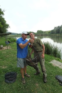 Fishermen, anglers, caught white fish (Leuciscinae) are weighed and then released, South Hungary,