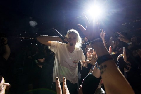 Emily Armstrong, lead singer of Linkin Park in the photo pit between the audience live on From Zero