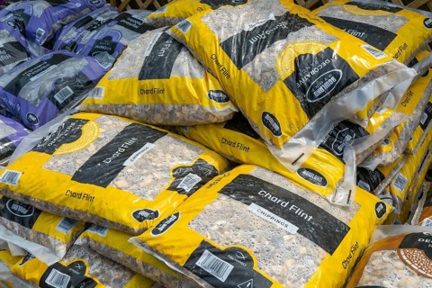 Chard Flint stone chippings bags stacked up at Lowden garden centre, Wiltshire, England, UK