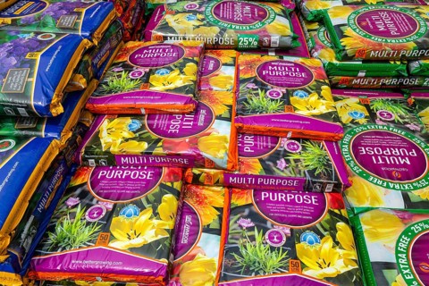 Multi Purpose compost bags stacked up at Lowden garden centre, Wiltshire, England, UK