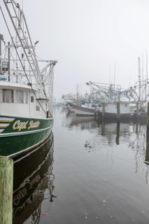 Commercial shrimp boats at the dock in the commercial area of the Biloxi Small Craft Harbor in