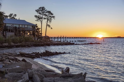 Sunset over the railroad bridge across Bay of Saint Louis from Henderson Point in Pass Christian,
