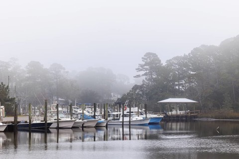Private fishing boats in the harbor at Ocean Springs, Mississippi on a foggy morning