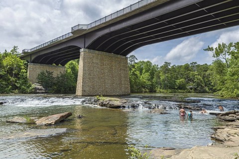 People playing on the rocks under the Little River Falls Bridge in Little River Canyon Falls Park