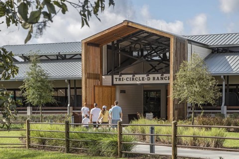 Family entering the Tri-Circle-D Ranch horse stables in the Fort Wilderness Campground and Resort