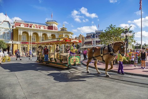 Horse pulling trolley car with Disney characters down Main Street in the Magic Kingdom at Walt