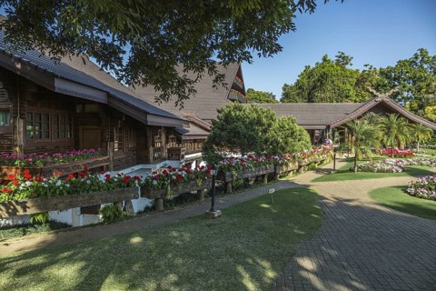 Ornate trees and lush flower gardens enhance the Lanna and Swiss architecture of the Doi Tung Royal