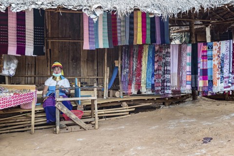 Tribal woman selling woven scarves and other crafts in the Long Neck Karen tribe (more properly