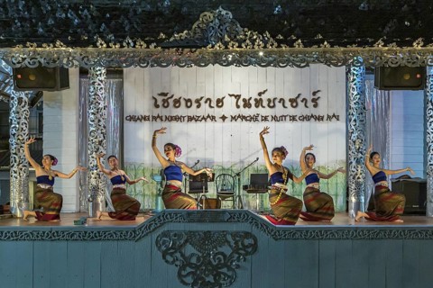 Traditional Thai dancers perform on a lighted stage at the night market in downtown Chiang Rai,