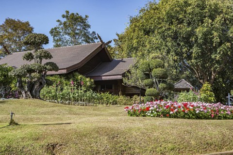 Ornate trees and lush flower gardens enhance the Lanna and Swiss architecture of the Doi Tung Royal