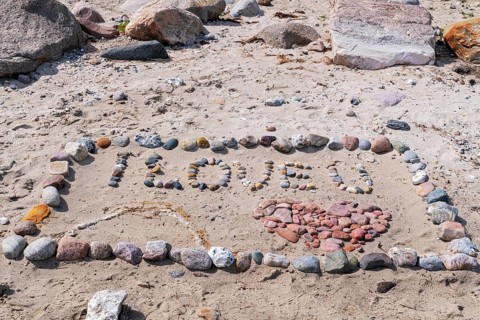 I Love You with heart on the beach with stones in the sand