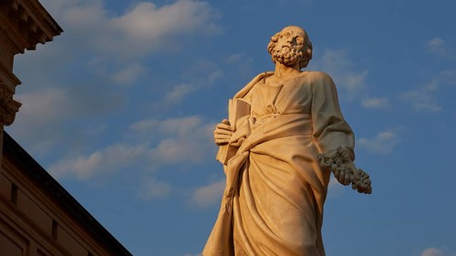 Cathedral of Syracuse, detail of a statue in front of a blue sky, part of a historic building,