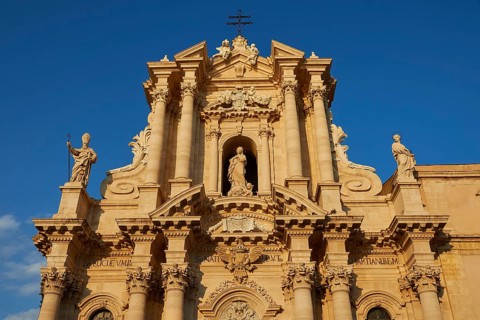 Cathedral of Syracuse, detailed view of the cathedral with sculptures and blue sky in the