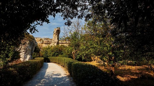 Park, A path leads through a sunlit landscape of ruins surrounded by trees and bushes, Neapolis