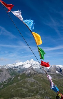 Böses Weibl summit with colourful prayer flags, view of picturesque mountain landscape with