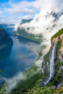 Gjerdefossen waterfall, at Ørnesvingen viewpoint, atmospheric clouds over the fjord in the morning