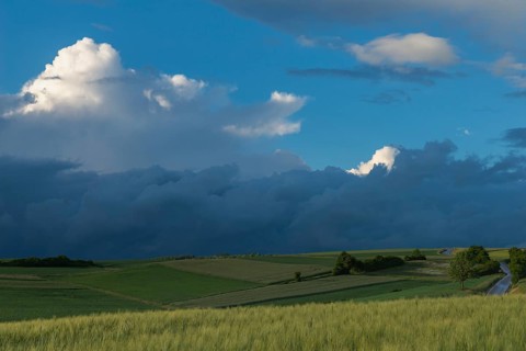 Dramatic cloudy sky with approaching storm and last rays of sunshine, Frankenhain, dark cloud wall,