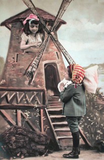 Children's windmill, miller, ca. 1910, Two children play a scene at a windmill in colourful