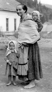 Farmer's woman and children, 1930s, A woman with two children in traditional dress on a dusty road,