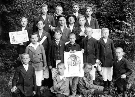 Young sports group with their awards, 1920s, boys in fine clothes, some with certificates, posing