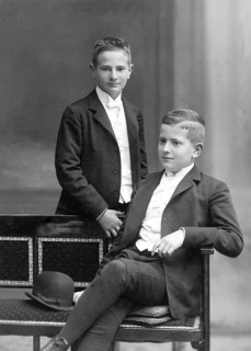 Two boys in suits, 1930s, Two boys in elegant suits pose confidently, one standing the other