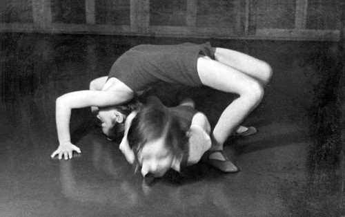 Children practising acrobatics, 1920s, Two children performing a gymnastic exercise on a floor,