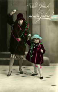 Good luck in the new year, 1930s, Two woman and a child throw snowballs and wish a happy new year,