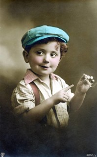 Little boy with a cigarette, 1930s, A boy in a colourful cap and shirt playfully holds a cigar and