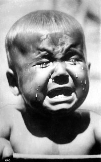 Crying child, 1920, A little boy cries bitterly, tears stream down his face in a black and white