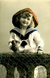 Girl in sailor look, 1920s, A boy in sailor clothes with pipe poses smiling, Historical photo