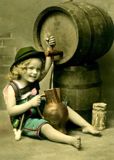 Girl tapping beer, 1920s, A girl in traditional clothing sits smiling next to a wooden barrel,