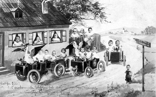 Two storks and a bunch of babies, 1920s, Children driving miniature cars on a rural road in a