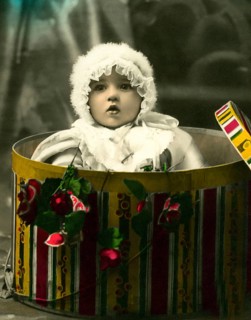 Baby in a gift box, 1930s, A toddler appears from a colourful box surrounded by flowers, Historical