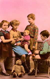 2 boys 2 girls, 1920s, Five children playing together with a doll in a nostalgic setting,