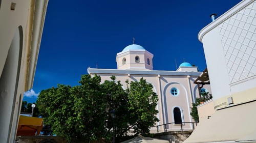 Mediterranean church with blue dome and green trees under a blue sky, Agia Paraskevi Church, Kos